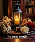 Lantern with a candle surrounded by flowers, illustrating usage for Six Pack Remote Timer Flameless Candles 2x2 LED Votive Lights Battery Operated.