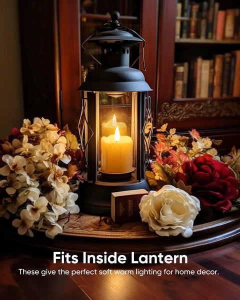 Lantern with a candle surrounded by flowers, illustrating usage for Six Pack Remote Timer Flameless Candles 2x2 LED Votive Lights Battery Operated.