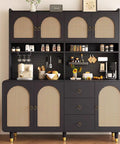 Contemporary kitchen storage cupboard with a dark finish and rattan doors, accessorized with various utensils and decor items.