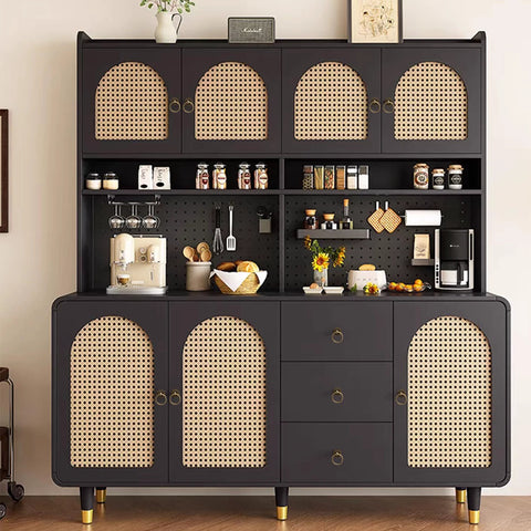 Contemporary kitchen storage cupboard with a dark finish and rattan doors, accessorized with various utensils and decor items.