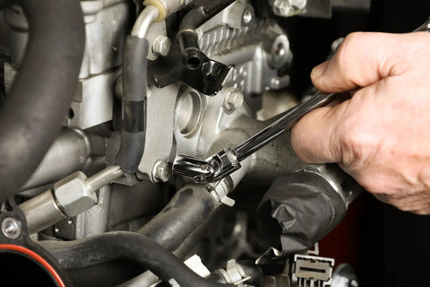 Mechanic using 12 Piece One Quarter Inch Drive Metric Flex Socket Set With 6 Point Sockets From 5mm To 15mm on engine part.