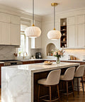 Vaziden Milk Glass Pendant Lights Kitchen Island Gold Chandelier 11.81" above marble island in a modern kitchen.