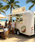 15 Foot White Food Trailer Fully Equipped No Sweat Turnkey Mobile Kitchen With Stainless Prep Area Plug And Play Beverage Station Road Ready Catering Rig Built Tough For Any Local Event at beach with customers ordering coconut milk.