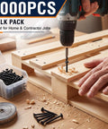Top Shelf Heavy Duty 3000 Piece Bulk Pack Size Six By Three Quarters Inch Drywall Screws With Coarse Threads And Bugle Heads Phillips Drive Black Phosphate Carbon Steel For No Sweat Wall Repairs being used with a drill on wooden boards.