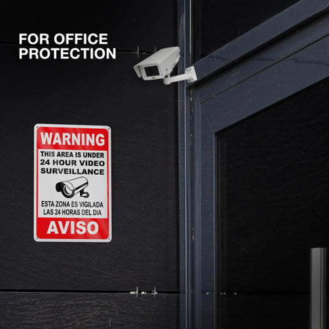 The Real Deal 24 Hour Security Camera Alert Eight By Twelve Inch Reflective Aluminum Yard Sign on office door, bilingual warning.