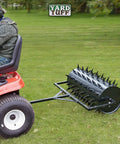 Man using 36 Inch Wide Lawn Aerator Roller With 78 Steel Spikes And 24 Gallon Water Holder for deep lawn aeration behind ATV on grass
