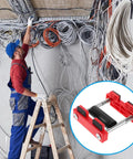 Electrician Pro Grade Cable Threading Tool With Time Saving Design And Versatile Compatibility For Wire And Cable Pulling In Junction Boxes And Sockets Smooth Cable Movement With Pulley System Easy One Handed Use In Durable Plastic And Steel Build. electrician using red plastic and steel cable threading tool on ladder in wiring room