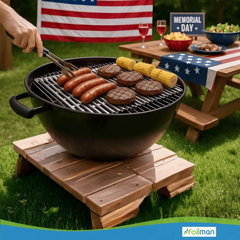 Outdoor BBQ with burgers and corn on a grill, picnic table in background, using Heavy Duty Disposable Aluminum Grill Liners 12 x 20 Inch Nonstick Sheets