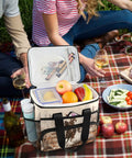 Insulated Lunch Bag With Shoulder Strap, Rugged Cooler Tote for picnic on plaid blanket with fruits and snacks, 15L capacity.