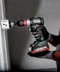 Heavy Duty Brushless Cordless Drill Driver With No Fluff Quick Change Accessories And Real World Torque Built For Tough Job Sites Pro Builders And Weekend Hackers in use, drilling into wall.
