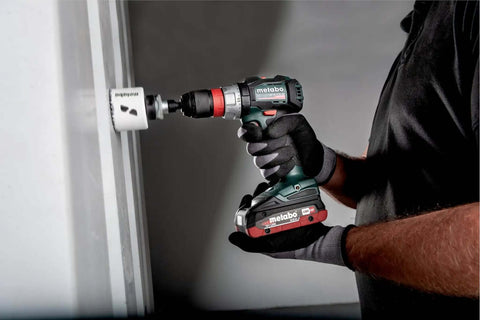 Heavy Duty Brushless Cordless Drill Driver With No Fluff Quick Change Accessories And Real World Torque Built For Tough Job Sites Pro Builders And Weekend Hackers in use, drilling into wall.