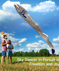 Family flying Massive 61ft Silver Soft Parafoil Beltfish Kite With Reel in a grassy field against blue sky.