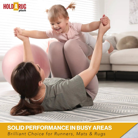 Mother on rug lifting child, illustrating safe play on Nonskid Rug Pad 3' x 5' Plush Reversible Gripper One Quarter Inch Thick.