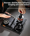 The Real Deal 5 Piece Espresso Tamping Station Kit With Spring Loaded Tamper, weighted distributor in use on a black counter.