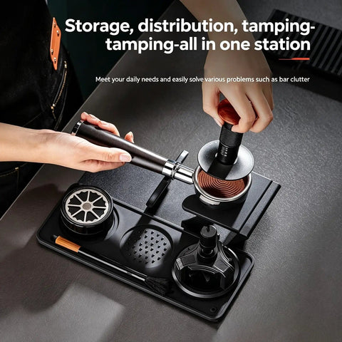 The Real Deal 5 Piece Espresso Tamping Station Kit With Spring Loaded Tamper, weighted distributor in use on a black counter.
