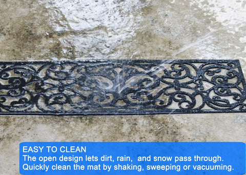 Outdoor Non Slip Rubber Stair Treads Set Of 4 With Stay On Kit Butterfly Design Anti Slip Mats For Steps 30 X 10 Inches Decorative Iron Grill Look Includes Carpet Tape For Easy Install shown during cleaning with water spray showcasing its open grill design letting dirt and rain pass through easily.