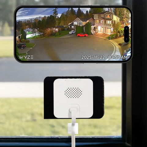 No Sweat Window Mount Security Cam With HD WiFi Live Streaming And Rock Solid Color Night Vision For Slick Home Protection and Smart AI Motion Detection That Plays Nice With Alexa And Google Home mounted on a window.