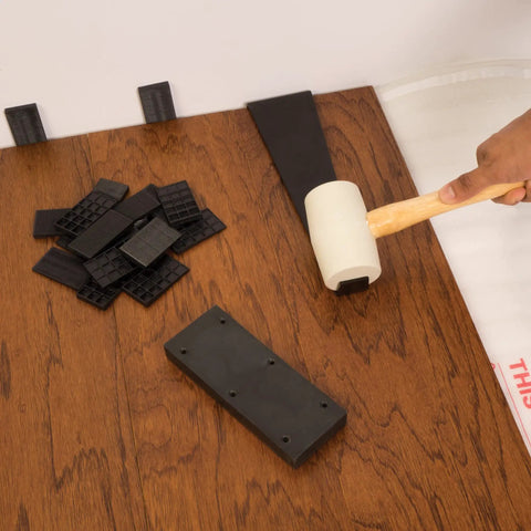 10-26 Laminate Floor Installation Kit With Spacers, Tapping Block And Pull Bar In Black, tools displayed on wood floor