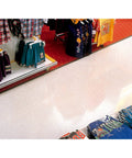 Shiny retail floor with Red 20 Inch Floor Scrub Pad For Spray Buffing And Light Cleaning, no visible soil scratches or scuff marks