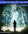 Person illuminated by Beast Mode 10000 Lumen LED Flashlight With Digital Power Display, showcasing powerful light output in forest.