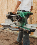 Person carrying MultiVolt 36V Sliding Miter Saw With 10 Inch Blade Dual Bevel Battery And Charger Included Cordless Or AC Powered
