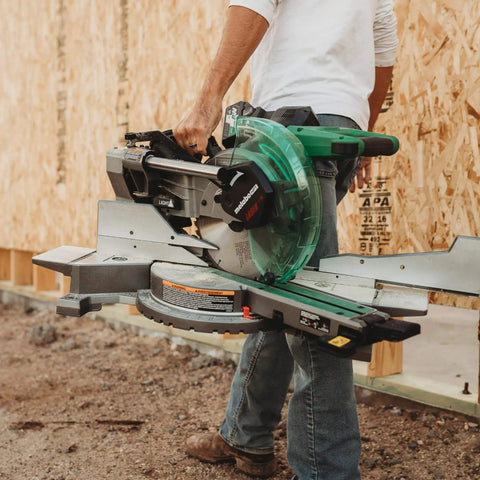 Person carrying MultiVolt 36V Sliding Miter Saw With 10 Inch Blade Dual Bevel Battery And Charger Included Cordless Or AC Powered