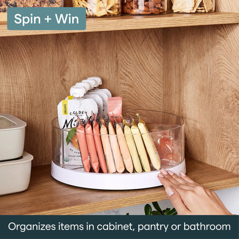 Smooth As Butter Three Bin Rotating Lazy Susan Turntable for cabinet organization with clear containers and snacks.