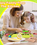 Toy kids knife set with green cutting board and colorful plastic utensils on kitchen table