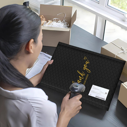Person using scanner with Black 4x8 Inch Bubble Mailers 50 Pack Padded Envelopes With Strong Adhesion And Cushioned Protection