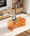 Orange Acrylic Coffee Table With Open Storage Two Tier Clear Modern Coffee Table For Living Room Office Reception And Bedroom Transparent Side Table With A Dope See Through Look And Durable Build in a living room with a laptop and bowl on top.