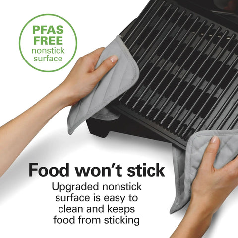 Hands holding PFAS-free nonstick grate of indoor searing grill with viewing window and adjustable temp to 450F 118 sq in