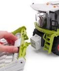Close-up of hand adjusting 1:24 scale Remote Control Farm Harvester with Lights Sounds and Smoke Effects attachment.