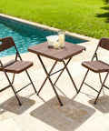 Sturdy Foldable 27 Inch Square Card Table With 400 Lb Capacity next to pool with two brown folding chairs on patio