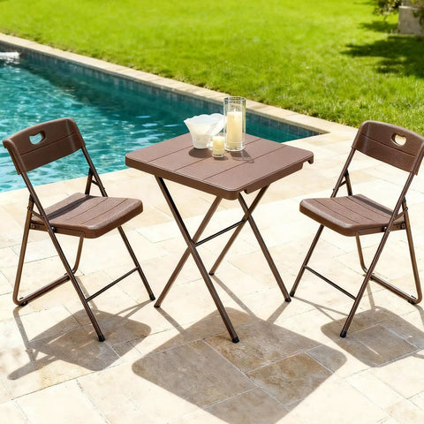 Sturdy Foldable 27 Inch Square Card Table With 400 Lb Capacity next to pool with two brown folding chairs on patio