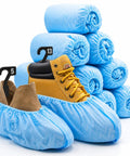 XL Disposable Booties - Thick 42GSM Non Slip Shoe Covers, Water Resistant for Indoor Outdoor Use with stacked rolls in background.