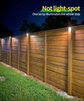 Outdoor Solar Deck Lights Set Of 6 Dope 7 Color RGB Waterproof Step Lights illuminating wooden fence at night