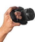 Micro Clutch L Plate Hand Strap for Mirrorless Cameras in use, showing low profile finger loop and ARCA compatible base.