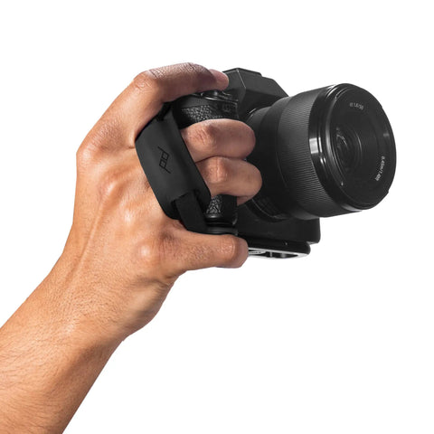 Micro Clutch L Plate Hand Strap for Mirrorless Cameras in use, showing low profile finger loop and ARCA compatible base.