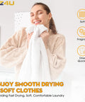 Woman enjoying soft and fragrant towel after drying with laundry machine