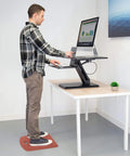 Man using Anti Fatigue Standing Desk Floor Mat For Home Office Kitchen Garage Red 18x22 Inch Rubberized Gel Foam Non Slip Washable Surface