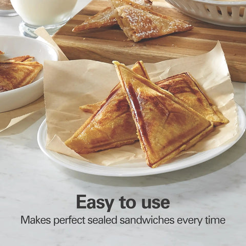 Hamilton Beach Electric Sealed Sandwich Maker Grill For Hot Pockets And Grilled Cheese creates sealed and toasted sandwiches on a plate.