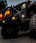 Off-road vehicle with Cyclone V2 LED 5W Flood Beam Light With Clear Lens, mounted on bumper, ideal for rock crawling and engine bays.