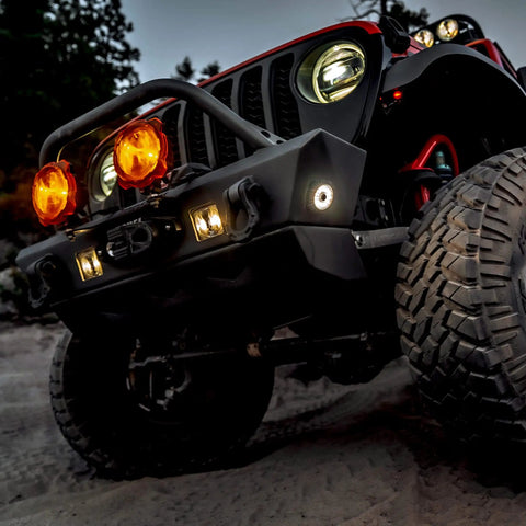 Off-road vehicle with Cyclone V2 LED 5W Flood Beam Light With Clear Lens, mounted on bumper, ideal for rock crawling and engine bays.