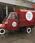 10.5Ft Turnkey Mobile Food Truck And Concession Trailer Featuring Three Serving Windows With Built In Commercial Kitchen Gear And Hella Spacious Storage For Your Startup Hustle That Gonna Take Off parked in front of a modern building.