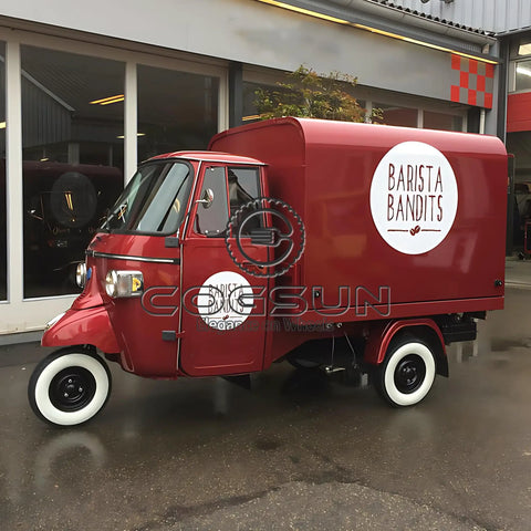 10.5Ft Turnkey Mobile Food Truck And Concession Trailer Featuring Three Serving Windows With Built In Commercial Kitchen Gear And Hella Spacious Storage For Your Startup Hustle That Gonna Take Off parked in front of a modern building.