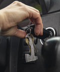 Hand holding Hatchet Keychain Dope Three In One Multitool For Everyday Carry With Bottle Opener Flathead Driver And Package Opener Clips