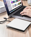 Plug And Play External CD DVD Drive For Mac And Laptop With USB Three Point Zero And USB C No Driver Required Slim White Optical Drive For PC And MacBook Ready Out Of The Box., slim white external CD/DVD drive connected to a MacBook