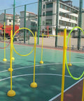 Drone Race Track Obstacle Kit For Indoor And Outdoor Flying on a basketball court, featuring yellow poles and rings.