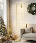 Industrial Floor Lamp With Light Bulb Included, tall metal standing lamp in brushed gold next to sofa and Christmas decor