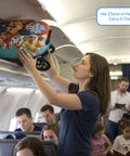 Paw Patrol ride-on luggage for kids in red/blue case with character art being loaded into an airplane overhead bin.